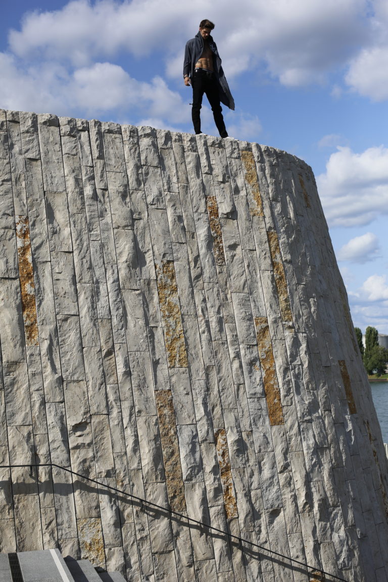 Christian Harmat standing on a wall.